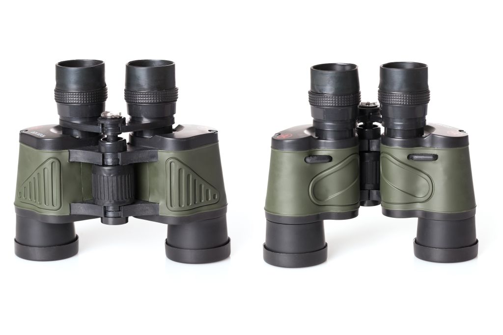 Two pairs of binoculars, one black and one green, on a white background