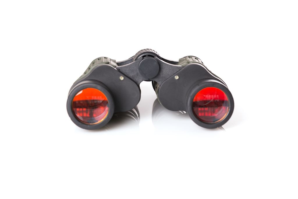 Binoculars with red lenses on a white background