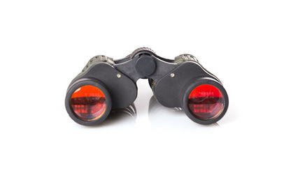Binoculars with red lenses on a white background